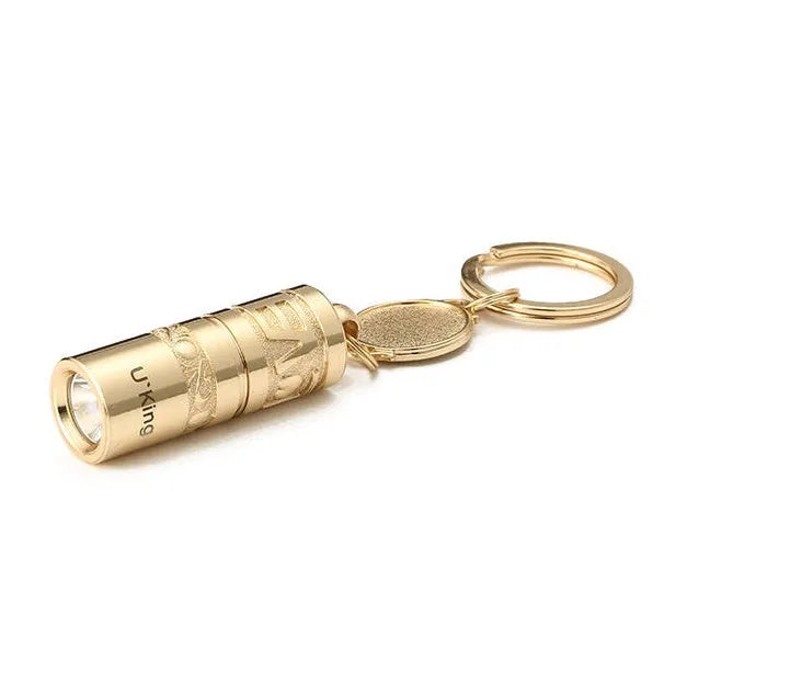 Gold electroplated zinc alloy portable LED keychain flashlight for outdoor emergency use.