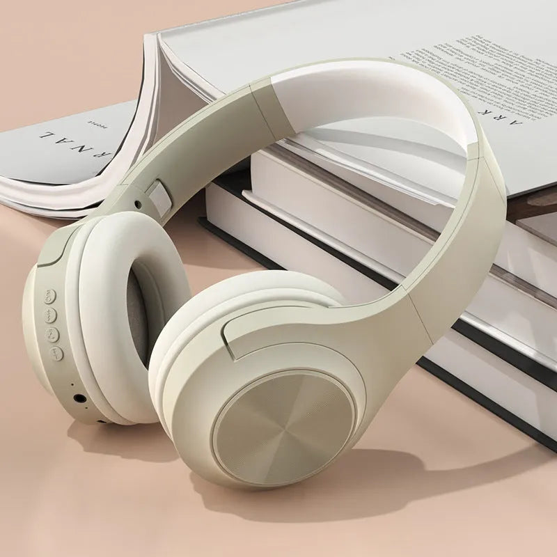 Creative head-mounted wireless Bluetooth headset in Ivory White colour on a charging bin.