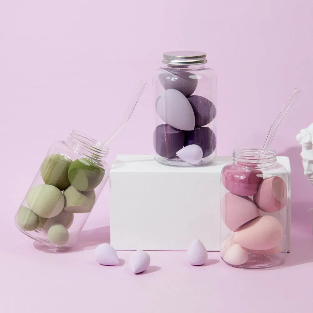 Set of 7 makeup sponge eggs in various colours inside transparent jar with multiple cut shapes