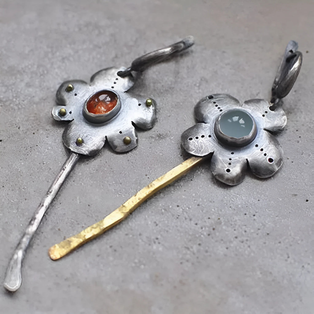 A pair of long retro earrings with asymmetric geometric flower shapes in a two-tone electroplated finish.