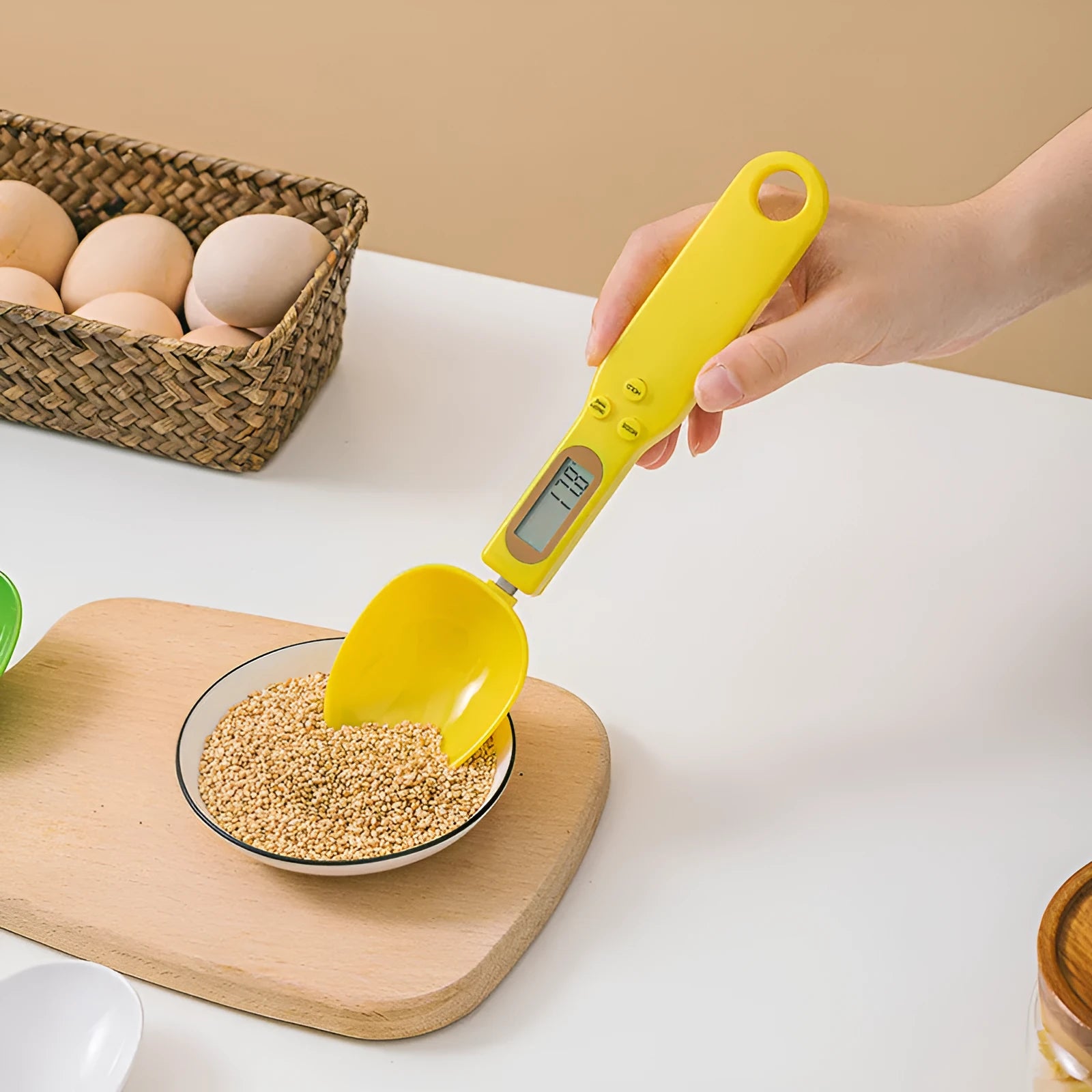 White digital kitchen scale with LCD display and spoon-shaped weighing surface for precise ingredient measurements