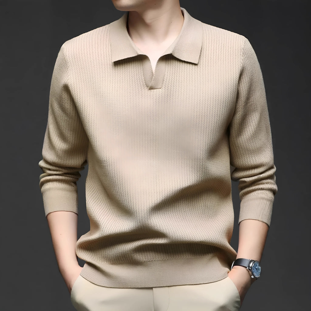 Man wearing a loose-fit green pullover sweater, a casual autumn garment.