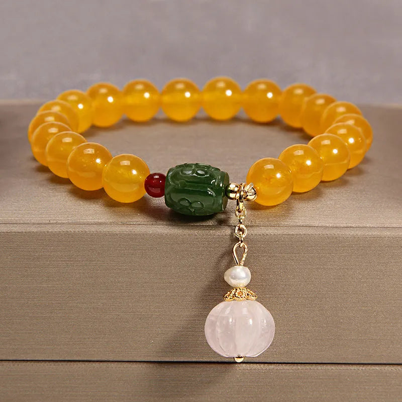 Women's adjustable crystal bracelet with yellow agate stones and gold silk thread.