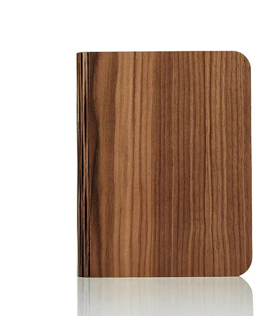 Solid wood USB book light in three sizes on a wooden table.