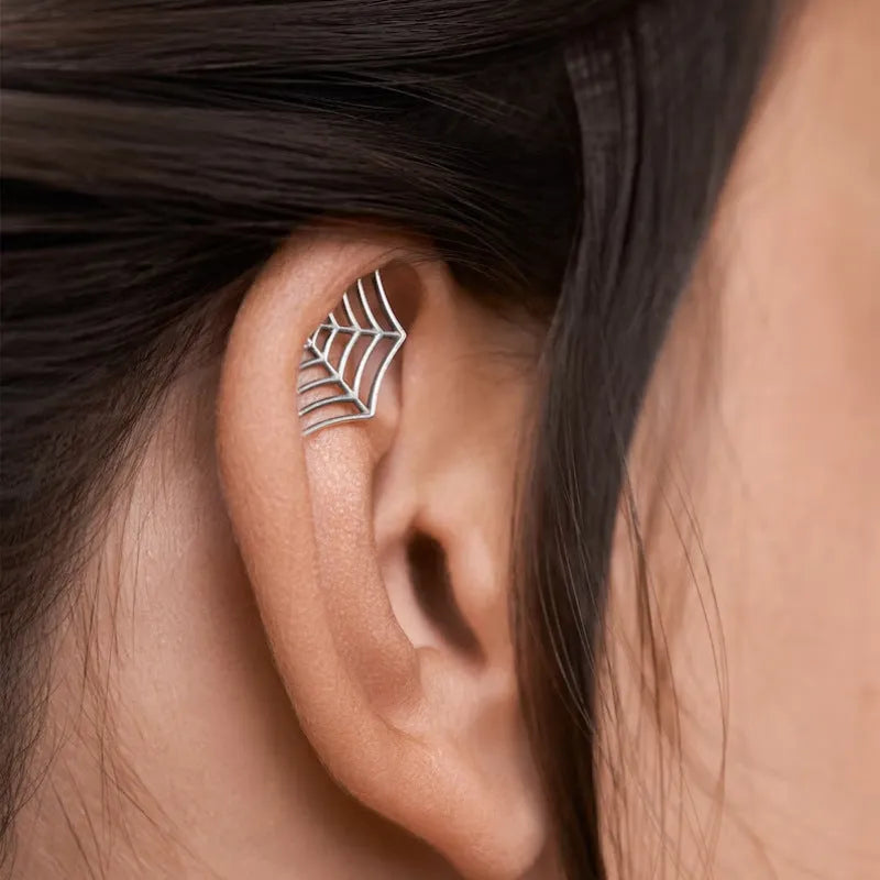 Geometric spider web stud earrings with electroplated gold finish and mesh patterning