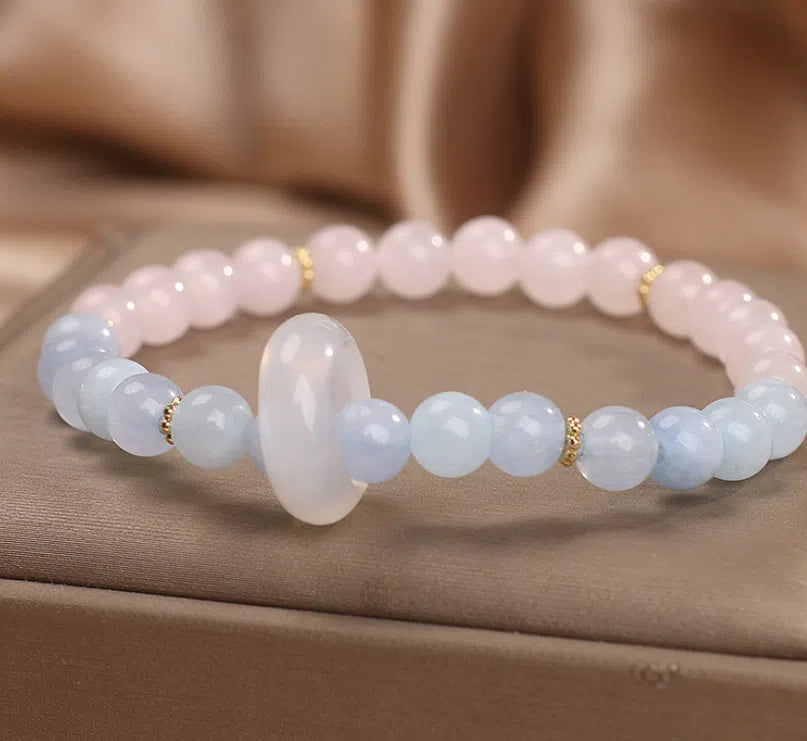 Natural aquamarine crystal beaded bracelet with pink electroplated finish on display
