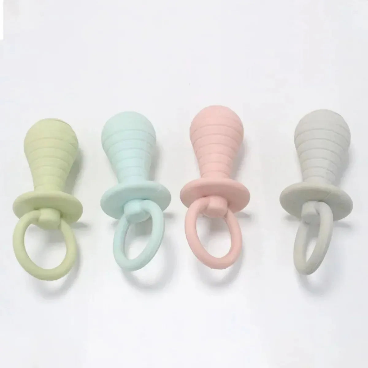 Set of four coloured TPR pet pacifier chew toys with squeakers for puppies and kittens.
