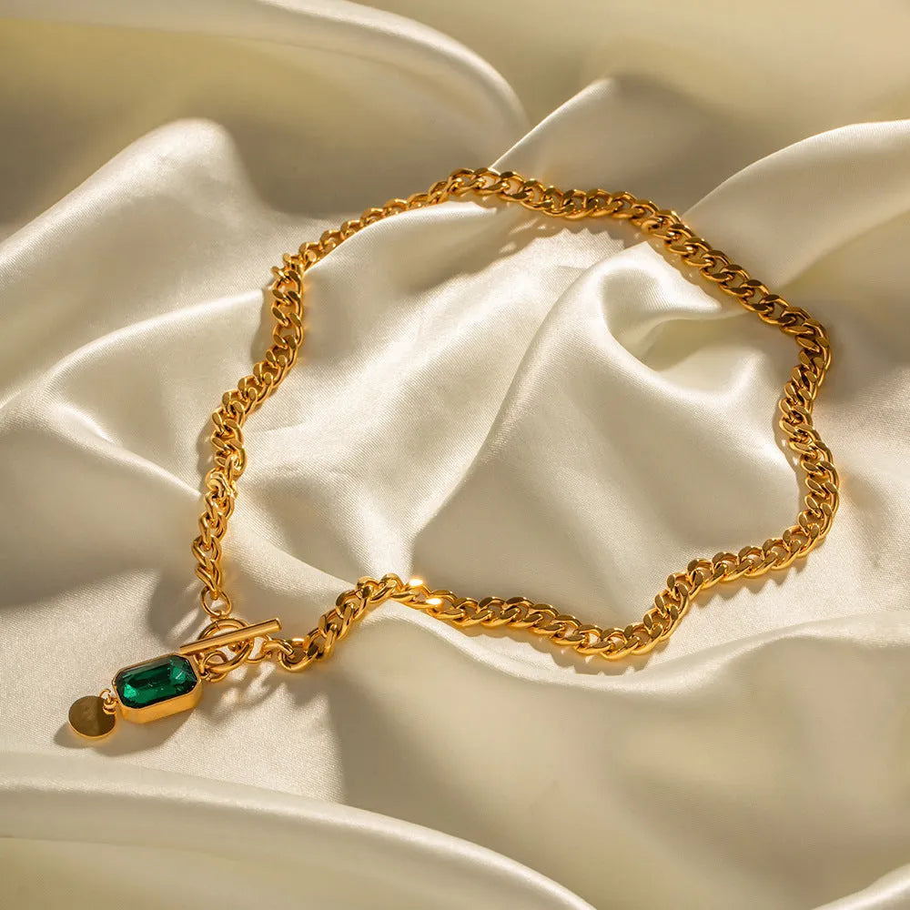 Gold electroplated titanium steel pendant necklace with emerald zircon stone in geometric round shape