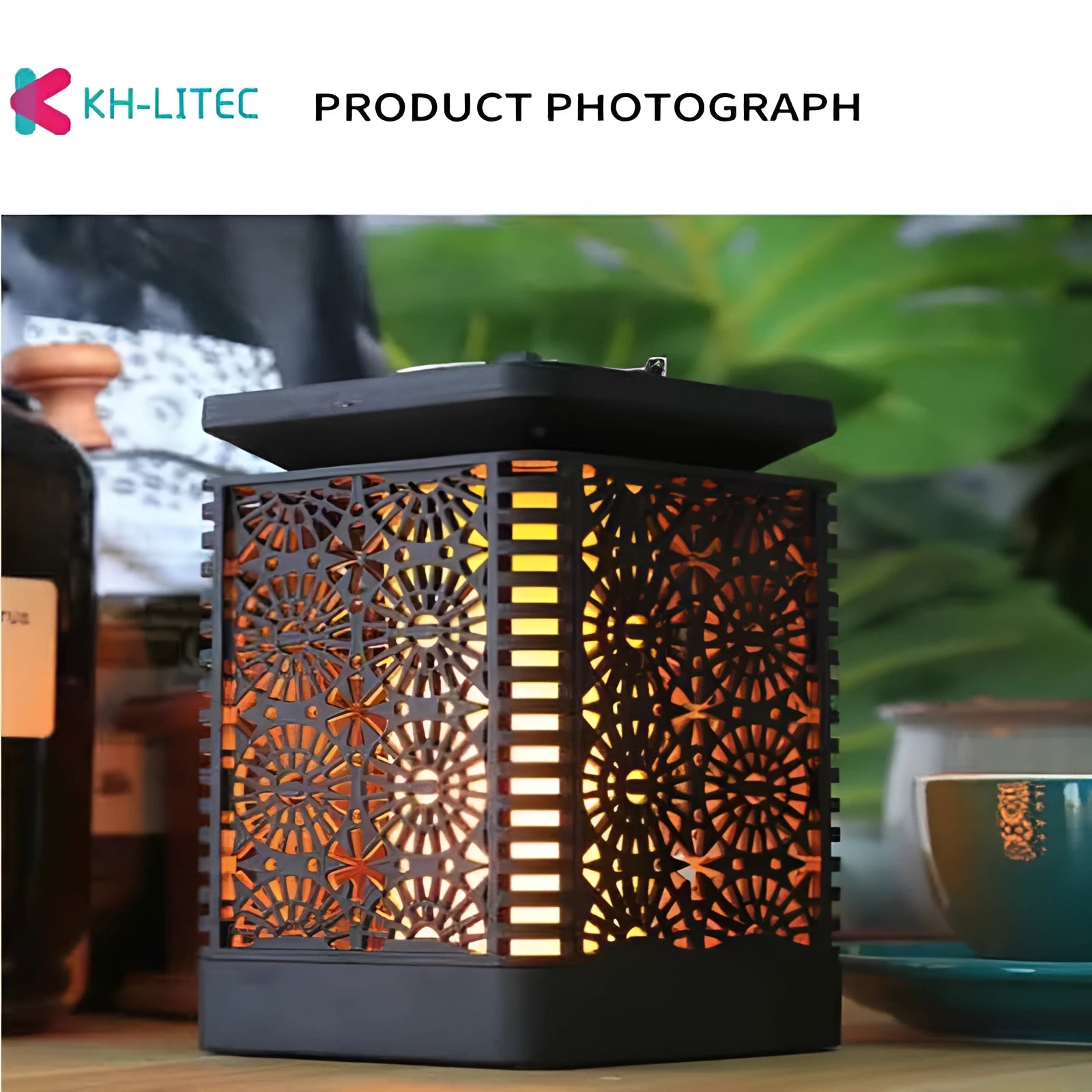 Set of four black solar-powered hanging lanterns with flickering flame LED light for outdoor garden decoration.