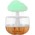 White raining cloud shaped micro humidifier with night light and essential oil diffuser on desk