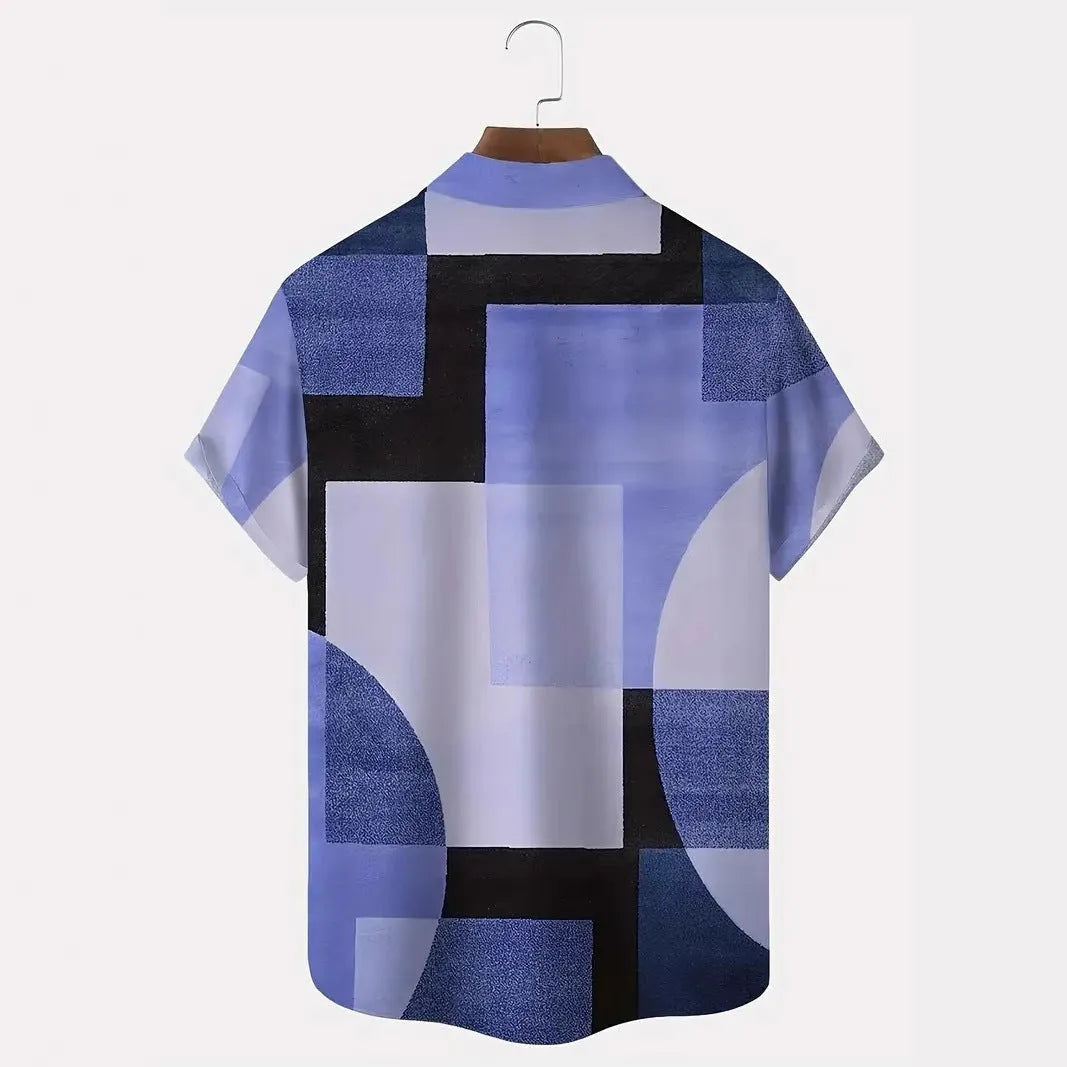 Man wearing a short sleeve cardigan with a blue and white retro geometric square print pattern.