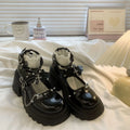 Black patent leather bat cosplay Lolita shoes with metal chain buckle and chunky heel on white background