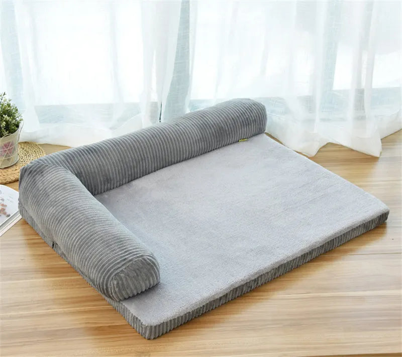 Corduroy bolster dog bed in grey with a removable cover, shown in a large (L) size on a hardwood floor.