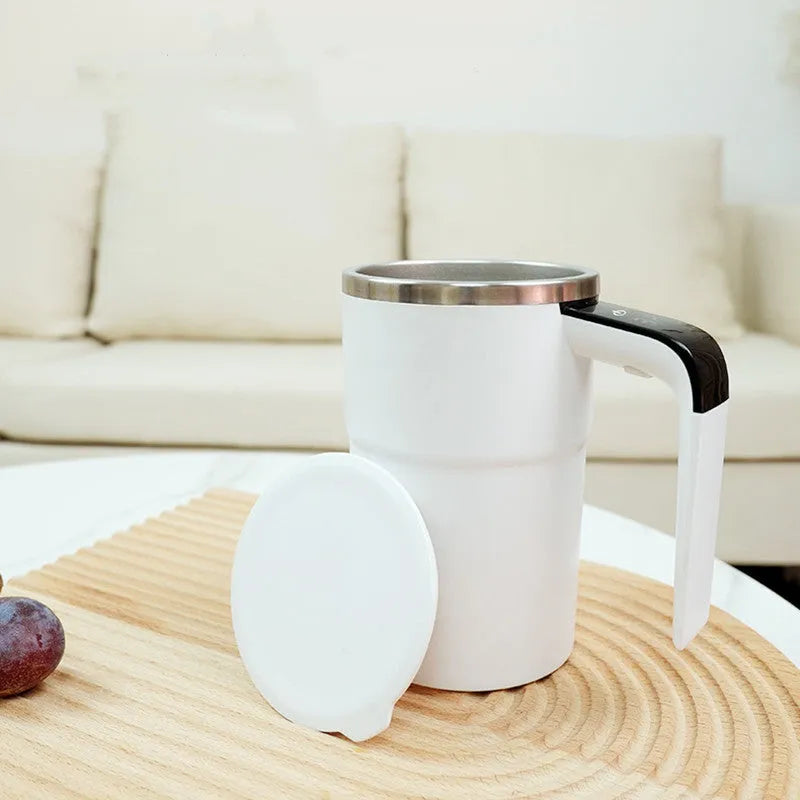 White electric coffee mug with LCD display showing temperature and magnetic stirring base