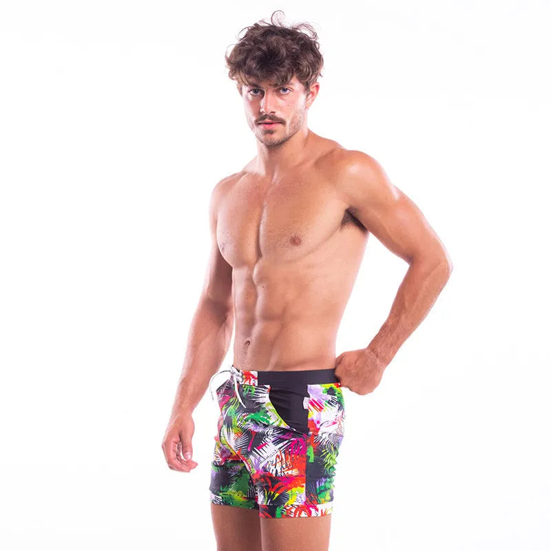 Men's spandex polyester swim shorts with elastic waist and drawstring on a beach background