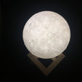 3D printed moon lamp showing detailed craters, with a touch metal ring at base for colour changing and dimming control.