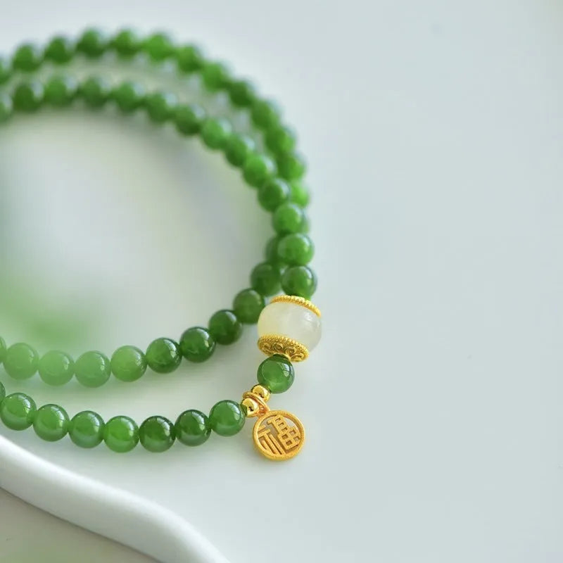 Women's double circle bracelet made of natural Hetian jade featuring a fu character symbol.