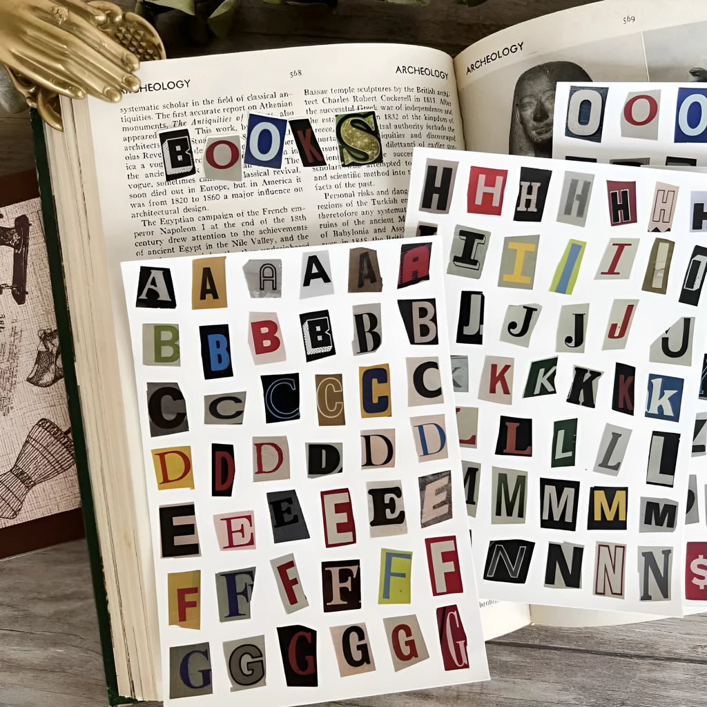 Sheets of cute printed stickers showing English letters A to Z, numbers, symbols, and weekly words like Monday and Friday.