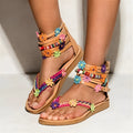 Ethnic style beaded petal sandals with floral design and round toe on artificial PU upper.