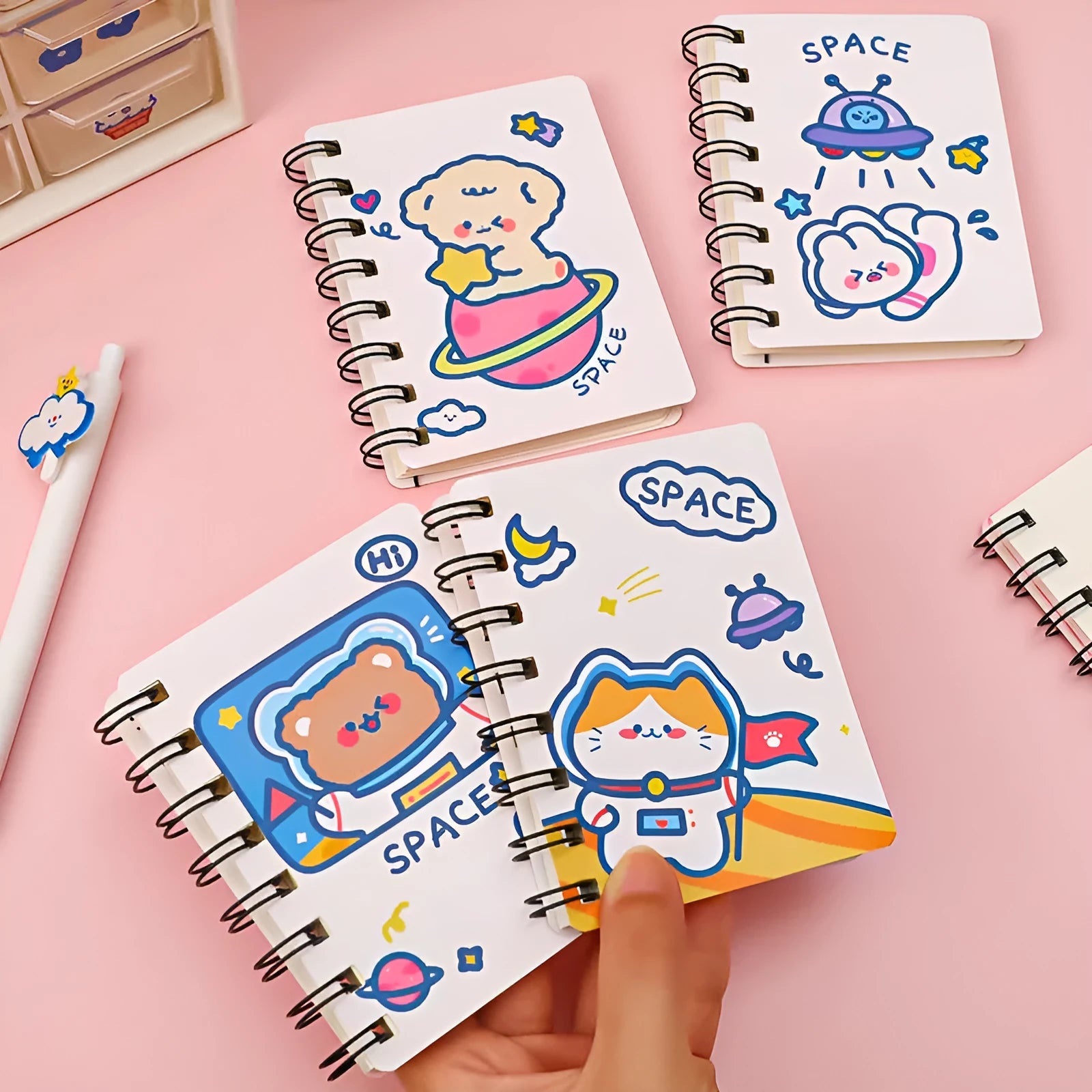 Astronaut-themed pocket flipper notebook showing compact 10.5cm by 8cm dimensions with flip-style binding