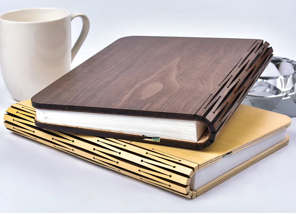 Walnut wooden book light open with colour changing LED pages on a desk