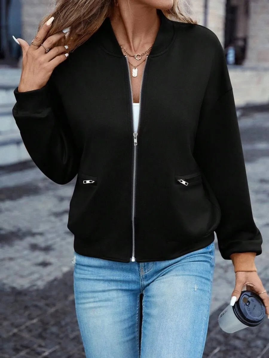 Women's solid black casual zip jacket with long sleeves, shown on a model.