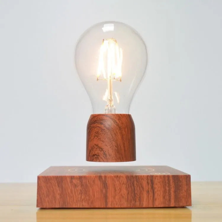 Magnetic levitating light bulb floating above an imitation wood base on a desk.