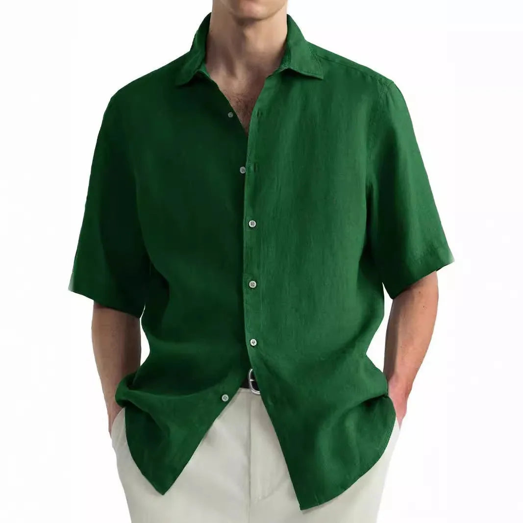 A man wearing a green washed cotton casual shirt, regular fit.