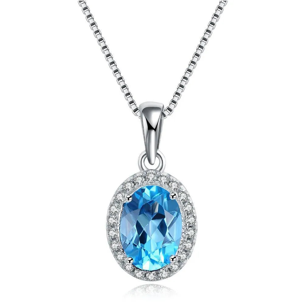 925 sterling silver geometric jewellery set with blue topaz gems showing earrings, ring, necklace, and pendant