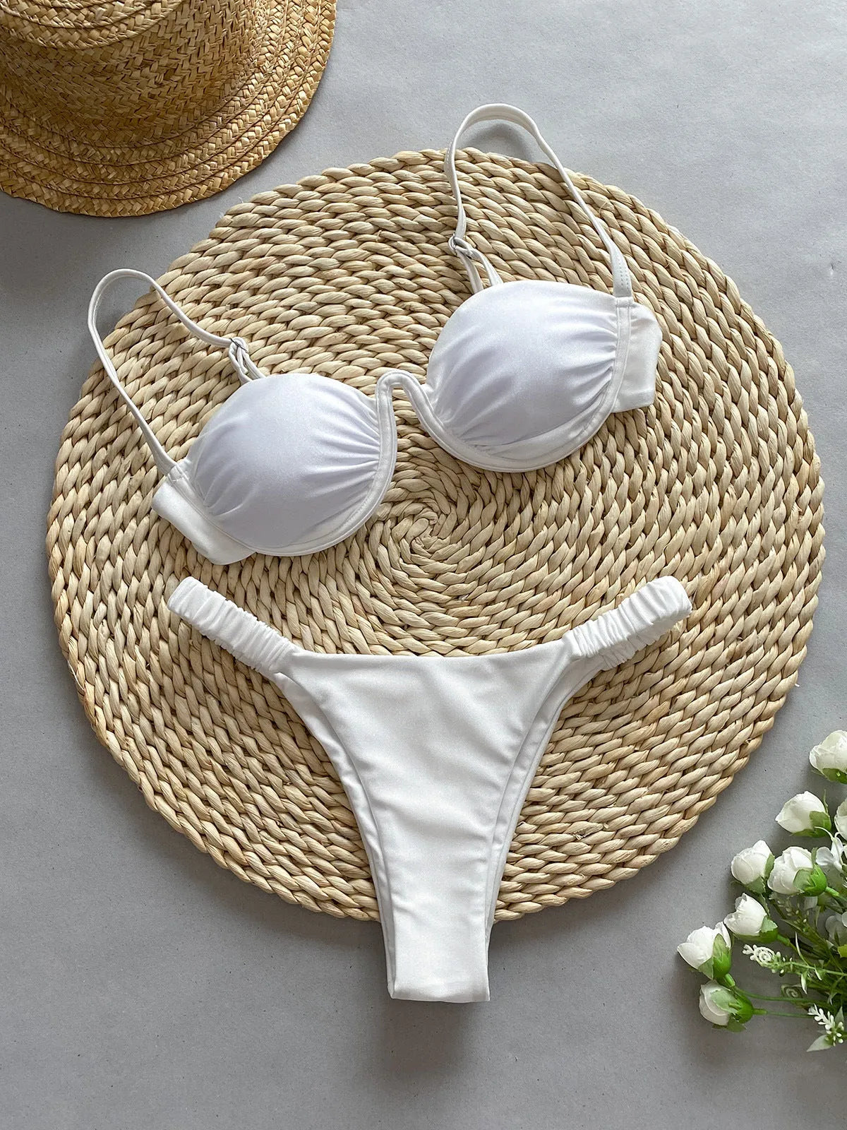 Women's black underwire bikini swimsuit set on a mannequin, showing sleeveless briefs style.