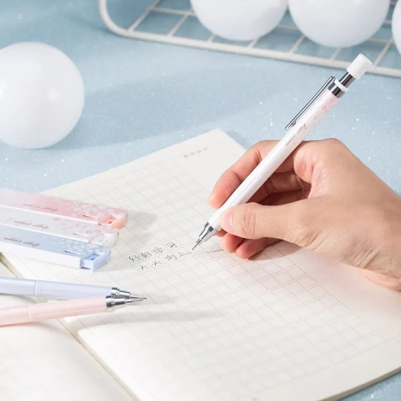 Cartoon design automatic pencil set with three 0.5mm pencils and HB refill boxes on a white background.