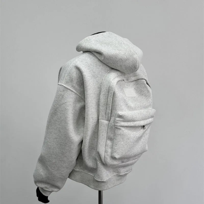 Light grey men's hoodie with backpack-style design on back, featuring a hood.