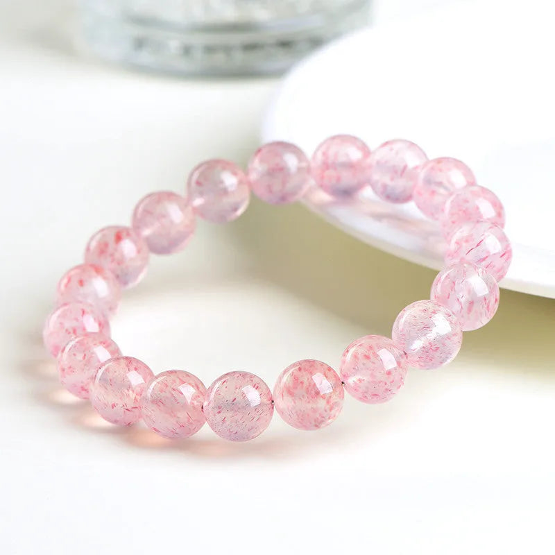 Strawberry quartz crystal bracelet with 10-10.8mm geometric balls in natural white water colour