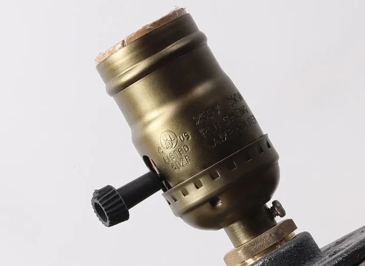 Small wooden and iron water pipe table lamp on a table