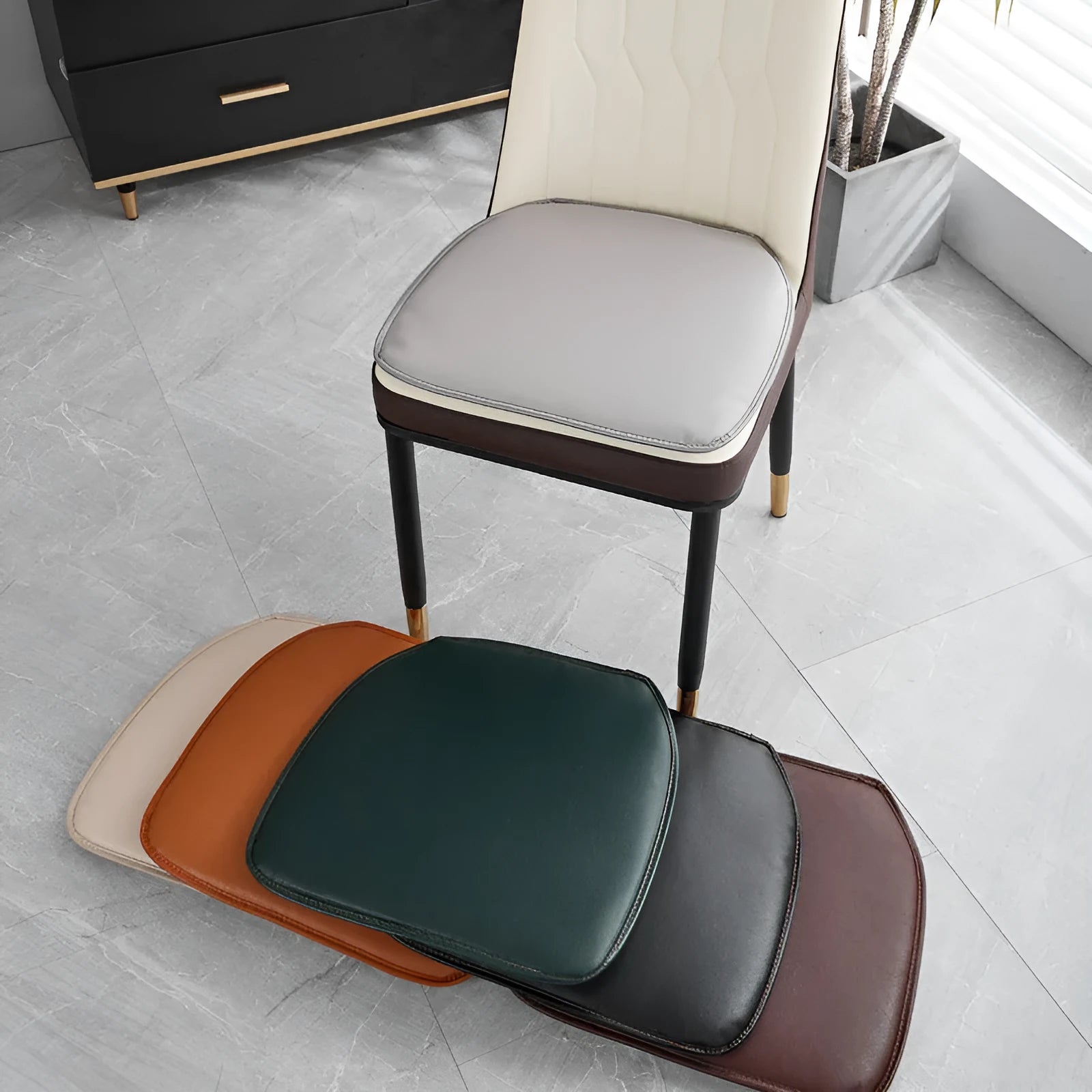 Orange leather horseshoe-shaped seat cushion with non-slip base on a wooden chair.