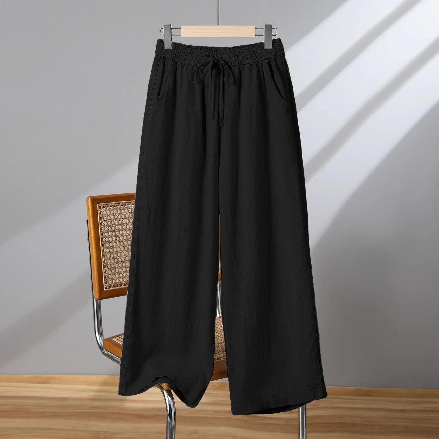 Women's apricot straight-leg casual trousers with elastic waist and drawstring detail laid flat