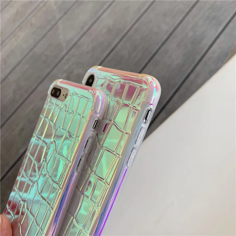 Silver glossy laser design silicone case for iPhone on a table.
