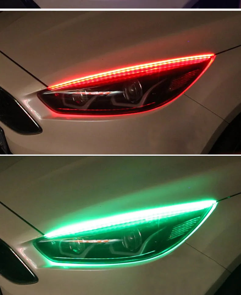 Close-up of a multi-colour RGB LED daytime running light strip with a remote control on a car bumper.