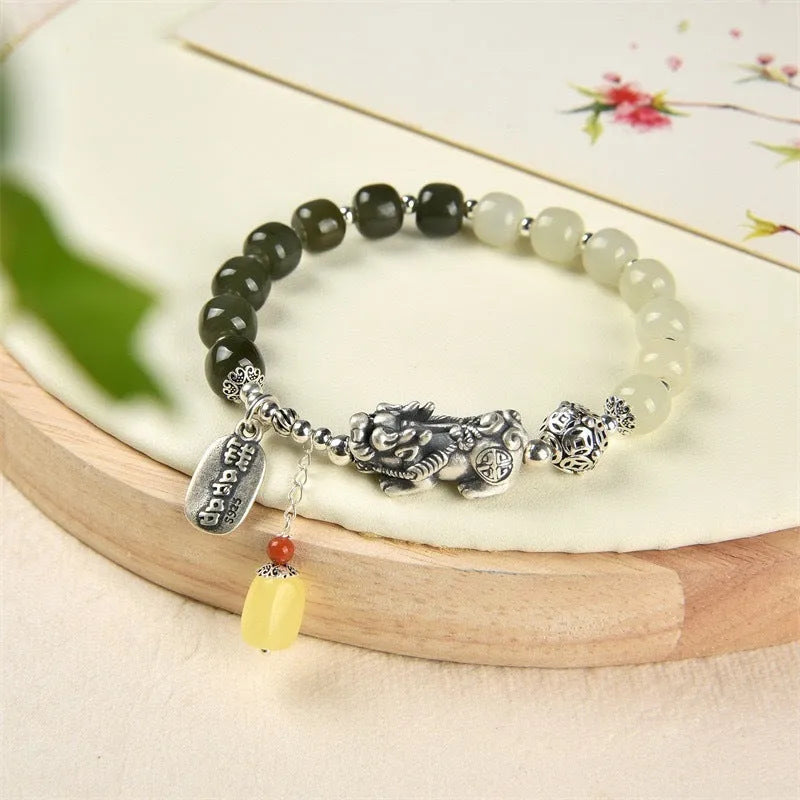 Retro-style pure silver bracelet for women with natural Hetian jade bead pendants.
