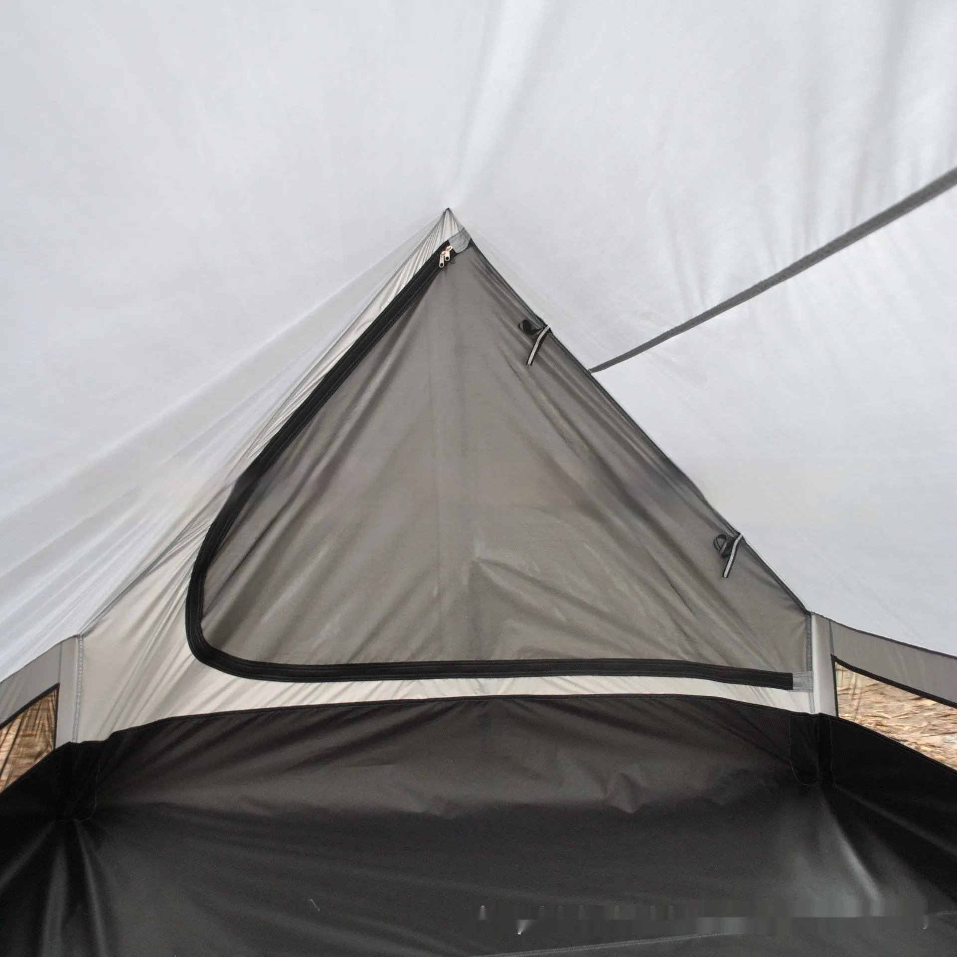 Brown A-line pole-free cabin tent pitched with hiking canes showing spacious interior dimensions