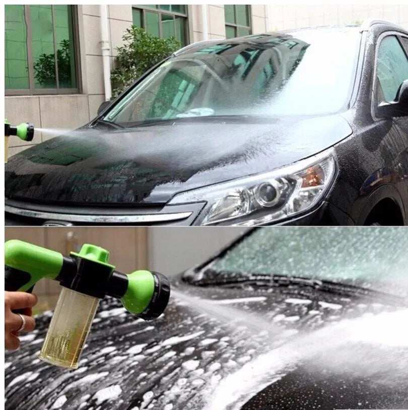 Green high-pressure foam spray gun with adjustable nozzle and connected water hose for car and garden cleaning.