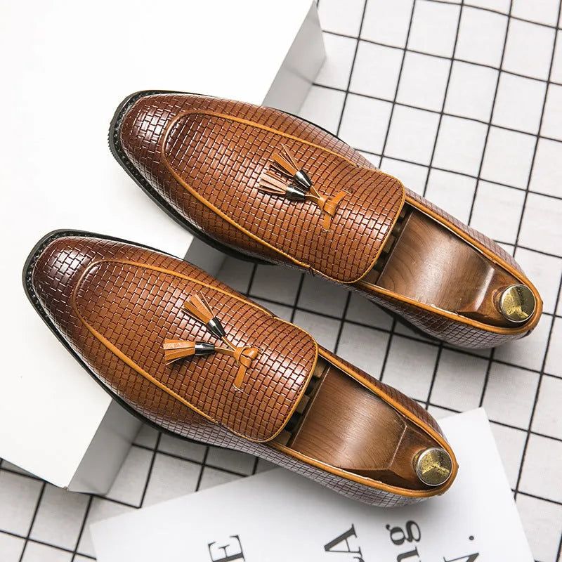 Men's black pointed-toe slip-on shoes with a tassel detail on the low-top PU upper.