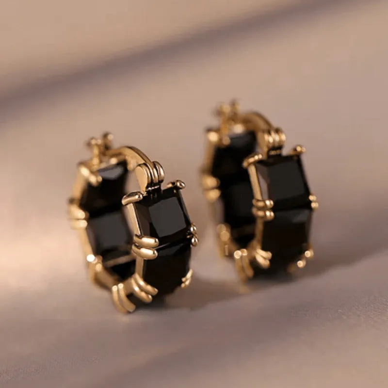 Geometric U-shaped drop earrings with zircon stones in black, pink or white colours on gold electroplated copper
