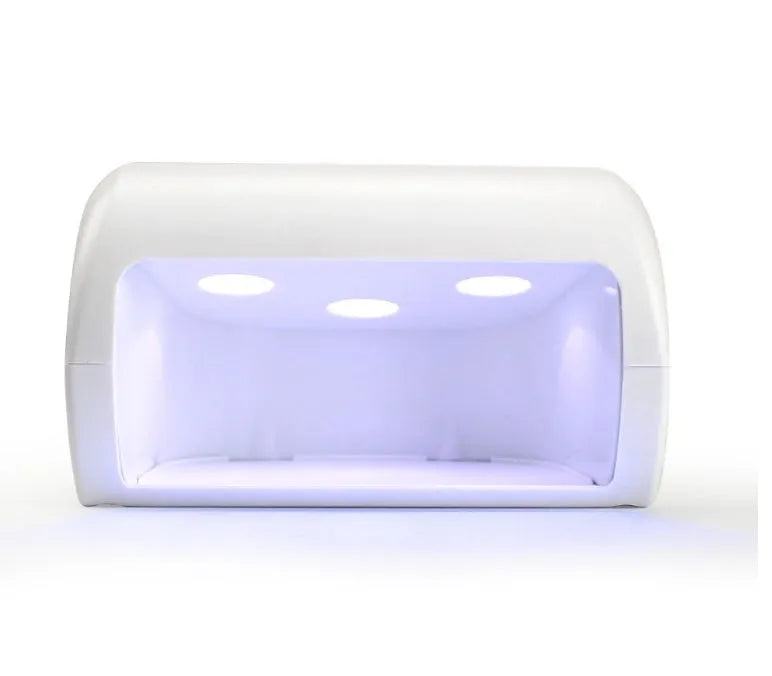 9W black LED UV nail lamp with dual light source and timer buttons on a white surface