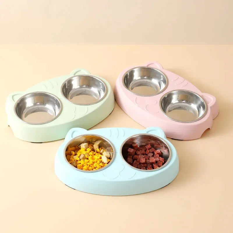 Blue plastic macaron-shaped double bowl pet feeder tray with a non-slip base and centre divider.