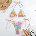 Women's floral print triangle bikini with smocking detail on the briefs, shown in multicolour.