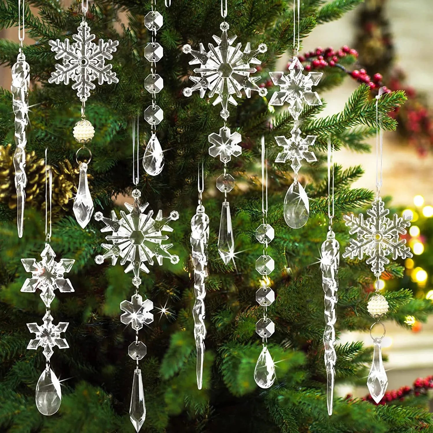 Ten clear transparent acrylic ice cone Christmas tree ornaments with white ribbons on green branches.