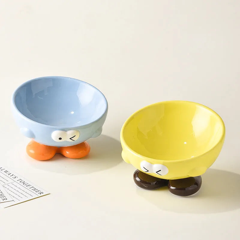 Blue oblique tall ceramic pet bowl with a cute expression design for cats and dogs.