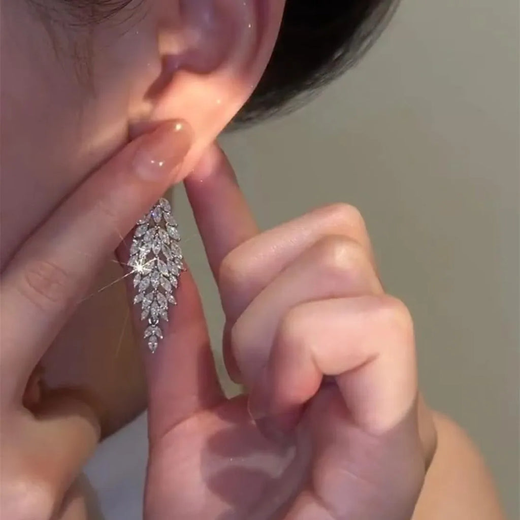 Silver anti-allergy auricular needle earrings with Japanese Korean style New Year design on alloy base