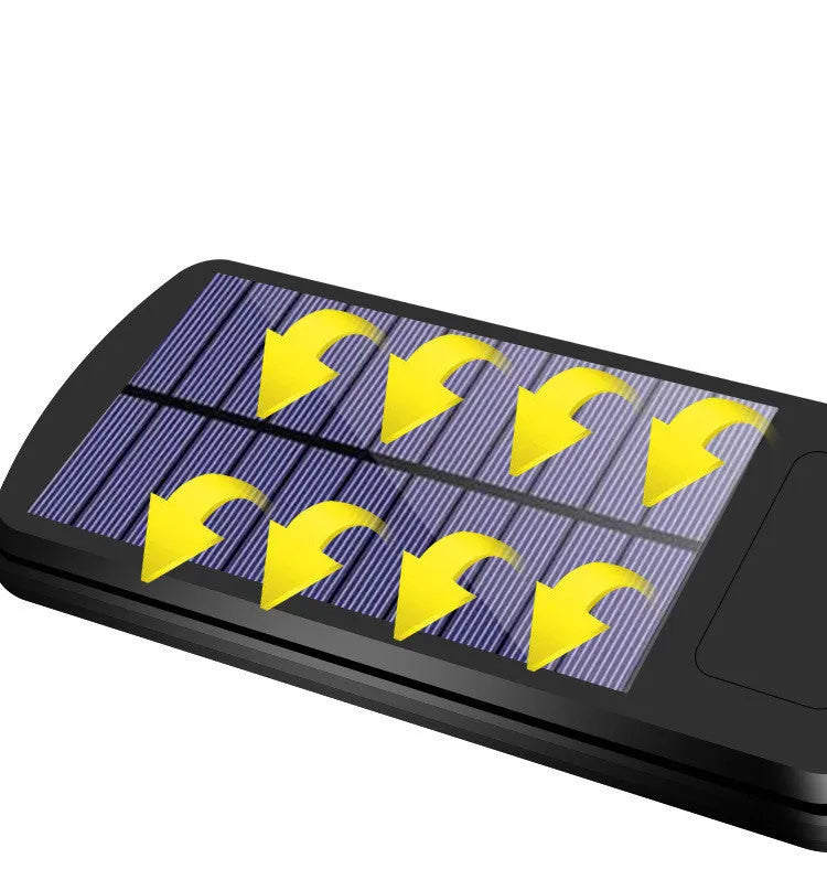 Black outdoor solar-powered security light with motion sensor on a wall.